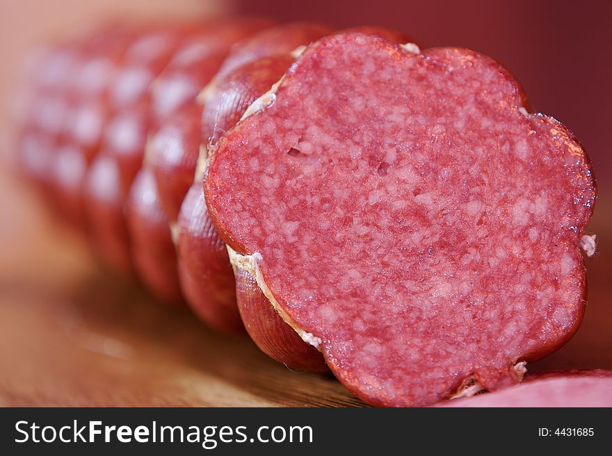 Slices of cooked smoked sausage isolated on white background