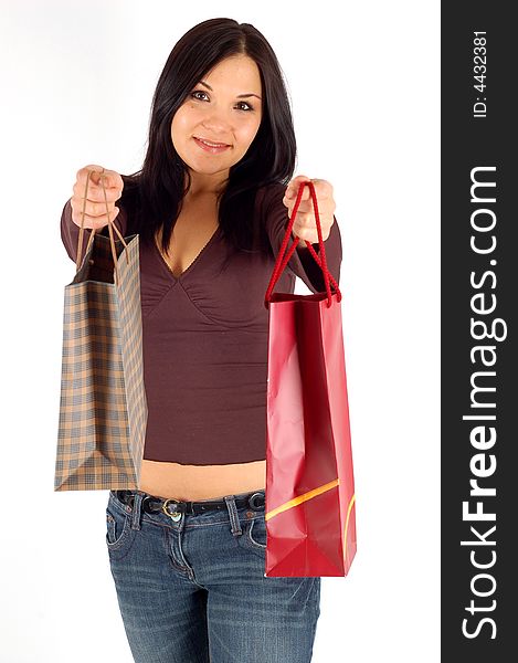 Attractive brunette woman with shopping bags on white background