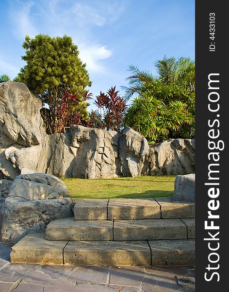 Steps leading into an ornamental landscape rocky garden as seen at sunset. Steps leading into an ornamental landscape rocky garden as seen at sunset