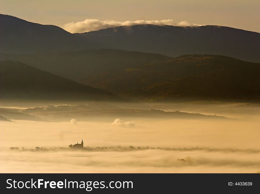 Church in the valley on the misty morning