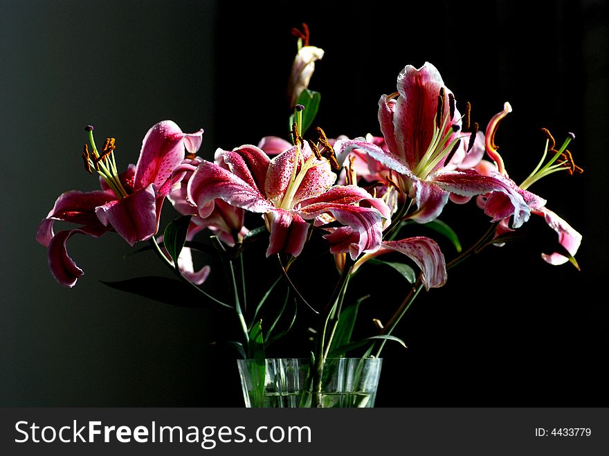 A bunch of lilies in a glass vase