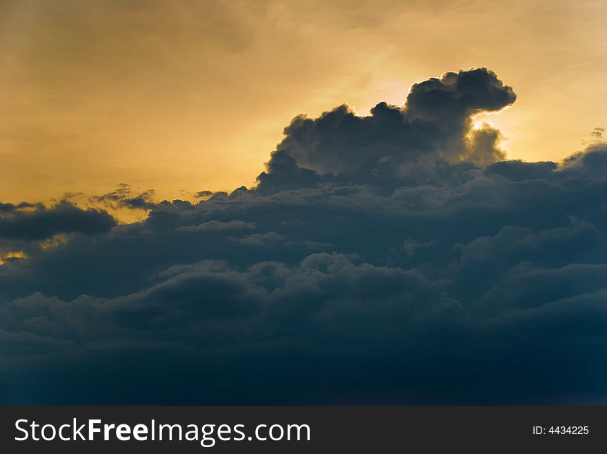 Dark clouds of a thunderstorm obscuring the sun at sunset. Dark clouds of a thunderstorm obscuring the sun at sunset