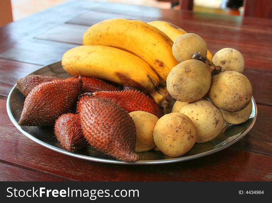 Rambutans, litchi and bananas on a dish - it would be desirable to have it by a breakfast every day. Rambutans, litchi and bananas on a dish - it would be desirable to have it by a breakfast every day