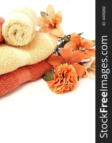 Beautiful bath ensemble with wash cloths and towels in burnt orange and sand colors on white.