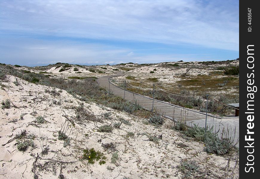Walkway in the dunes towards the sky