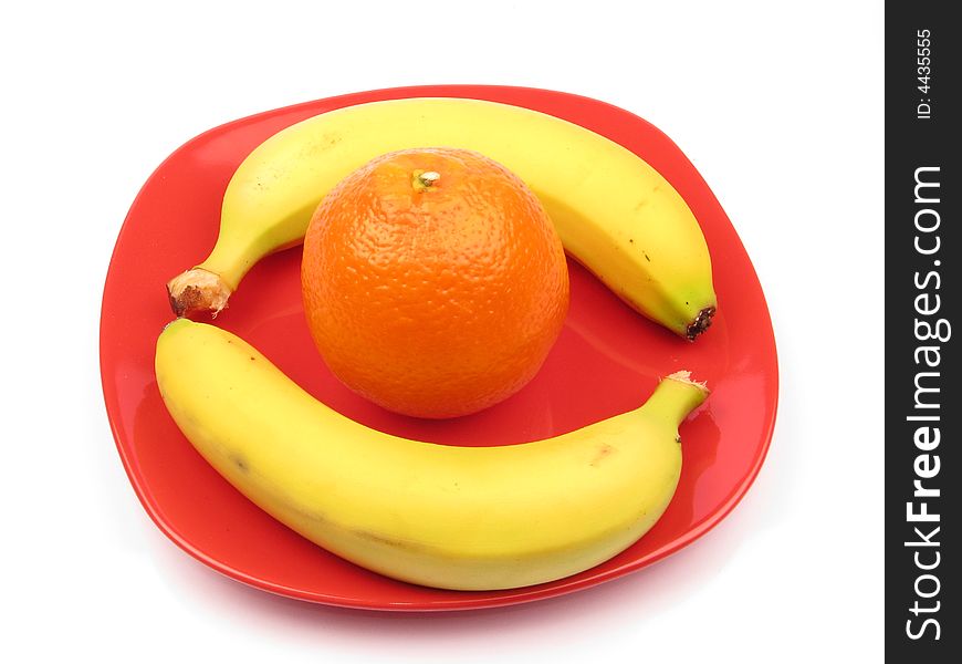 Two bananas and one orange on a plate. Two bananas and one orange on a plate