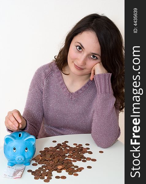 A young attractive woman with blue piggy-bank. A young attractive woman with blue piggy-bank