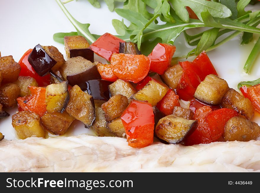 Stewed trout with stewed vegetables and fresh rocket salad. Stewed trout with stewed vegetables and fresh rocket salad