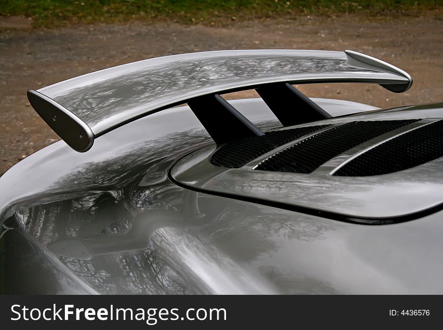 Rear spoiler on a grey english sportscar. Rear spoiler on a grey english sportscar