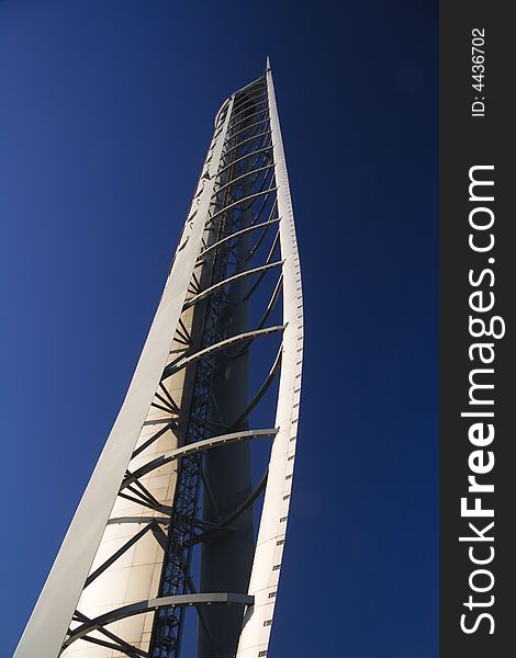 The winglike framework of the rotating Glasgow Tower reaches up into a blue sky. The winglike framework of the rotating Glasgow Tower reaches up into a blue sky