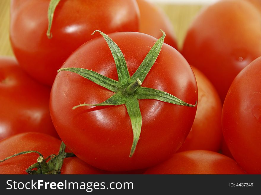 A fresh red tomatoes with a knife