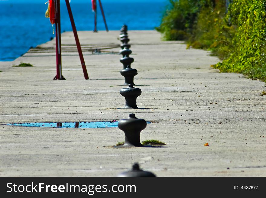 The harbour is empty of ship with a row of cleats