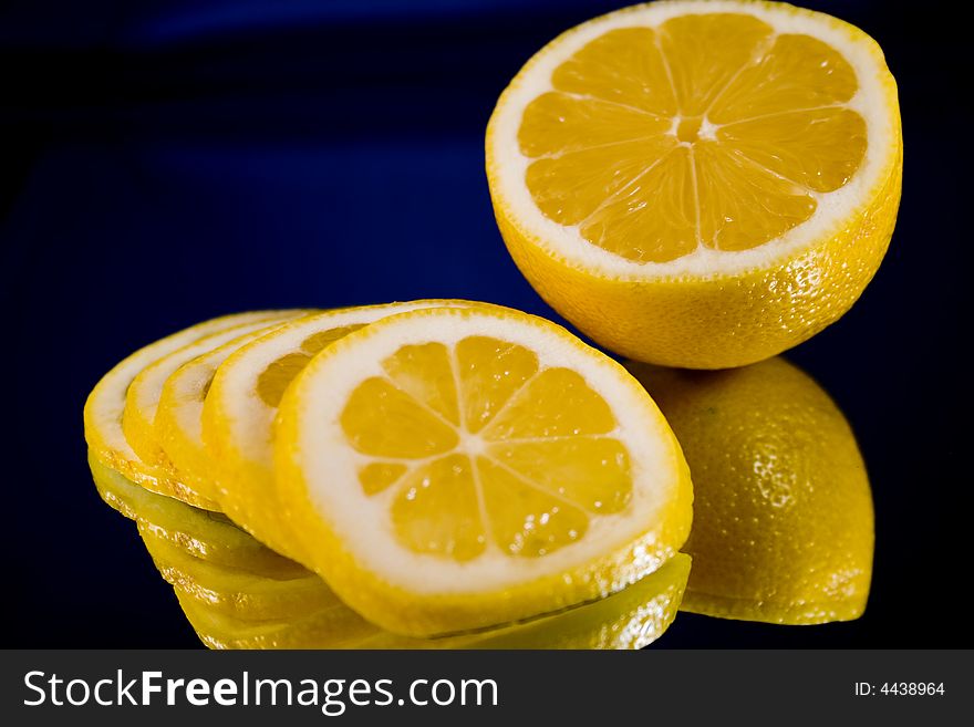 Lemon and Lime slices and halves against a dark background. Lemon and Lime slices and halves against a dark background