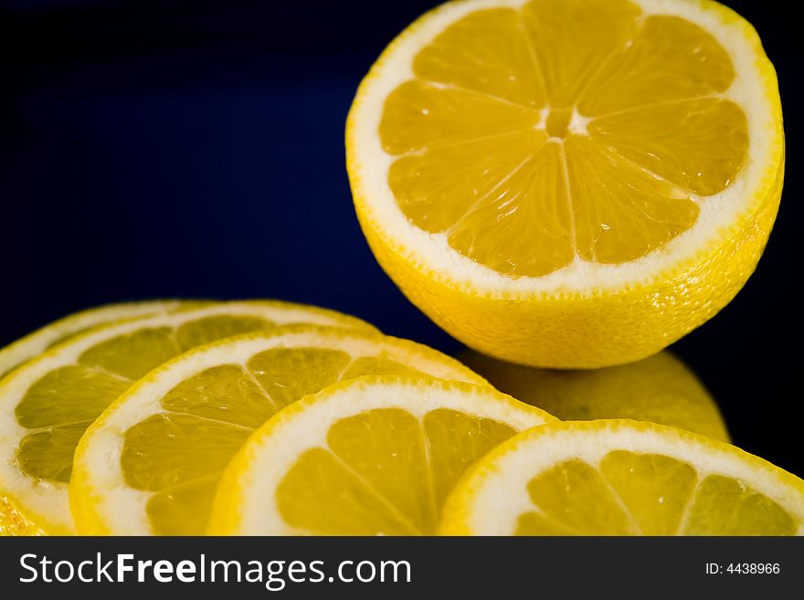 Lemon and Lime slices and halves against a dark background. Lemon and Lime slices and halves against a dark background