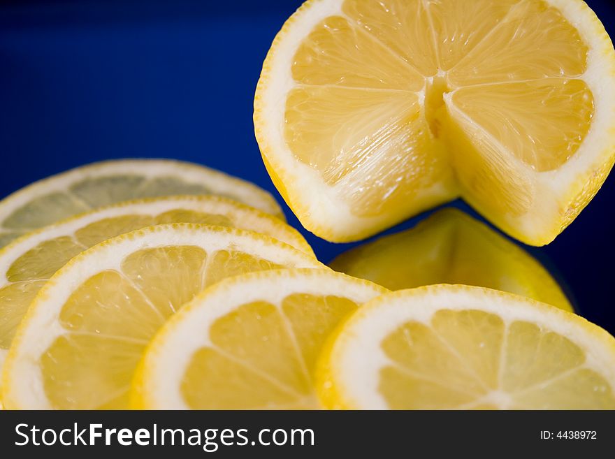 Lemon and Lime slices and halves against a dark background. Lemon and Lime slices and halves against a dark background