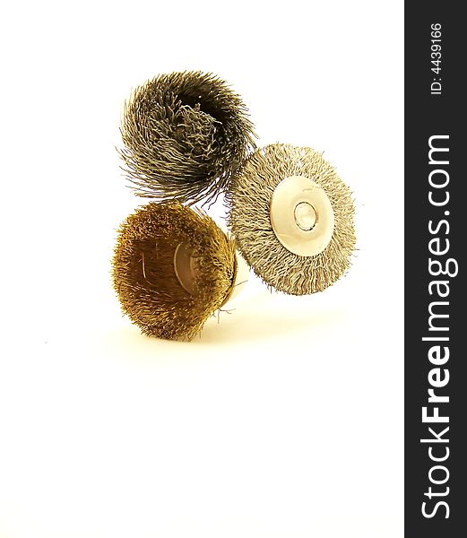 Image of three drill accessories with wire bristles, arranged vertically.