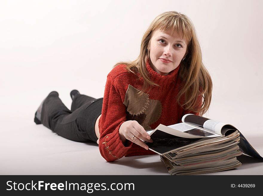An image of girl luing and reading magazines. An image of girl luing and reading magazines