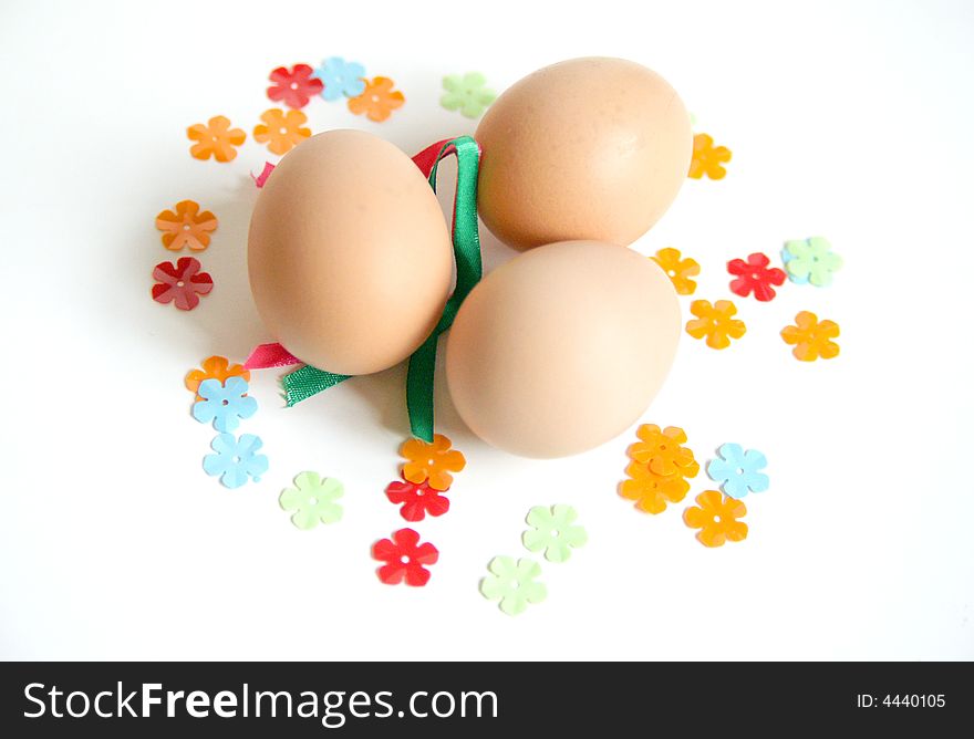 Plain eggs ready to be decorated for easter with ribbon and flower stickers. Plain eggs ready to be decorated for easter with ribbon and flower stickers