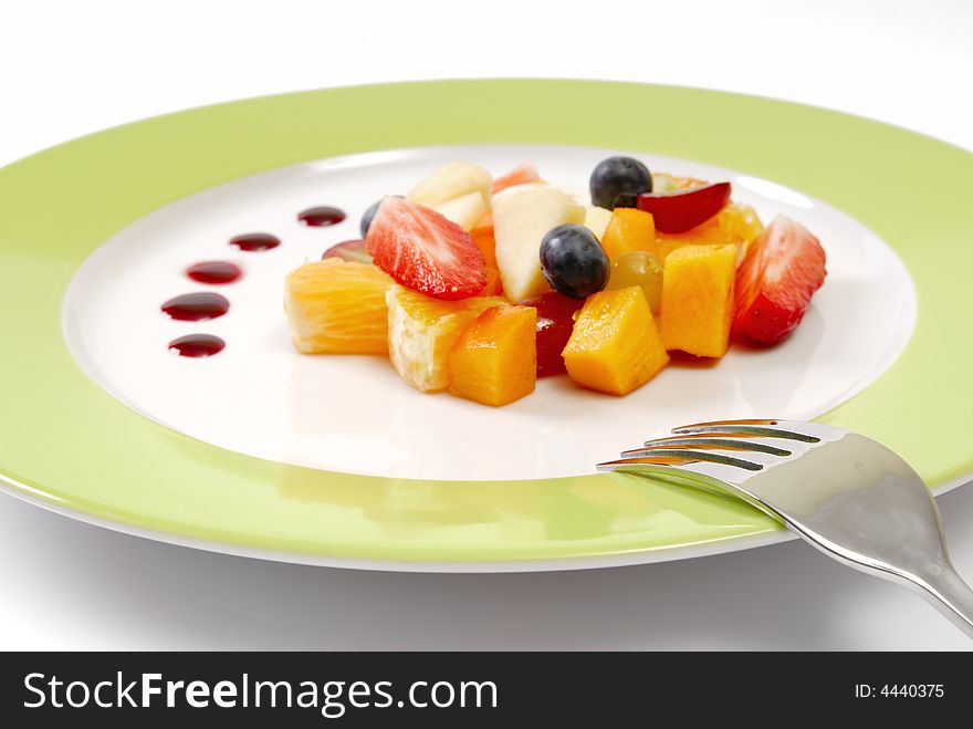 Fruit salad composition in front of a white background