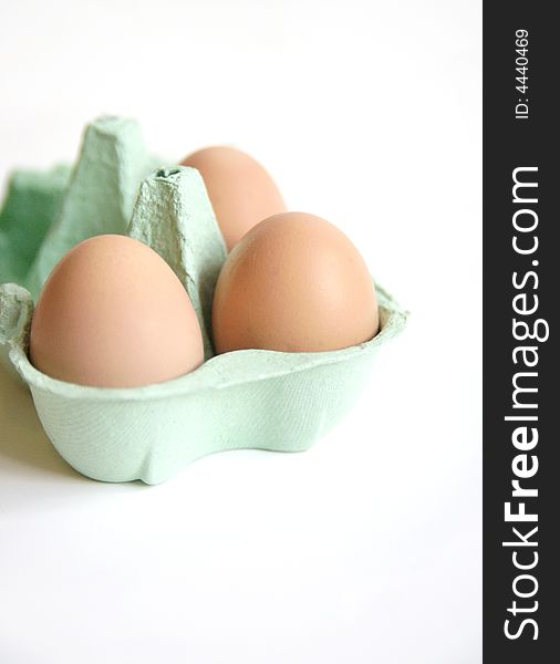Fresh free range eggs in green egg box on white background. Fresh free range eggs in green egg box on white background