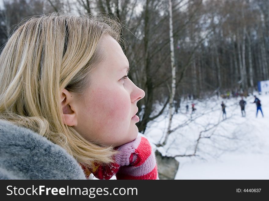 Young blond woman thinking at winter park