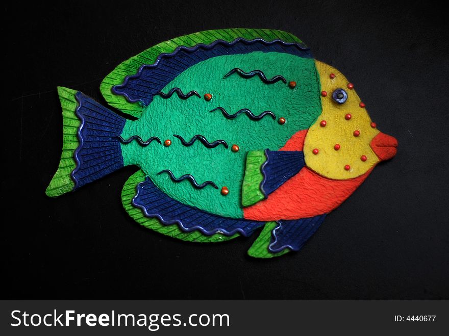 Tropical fish made from gypsum green body yellow face red mouth