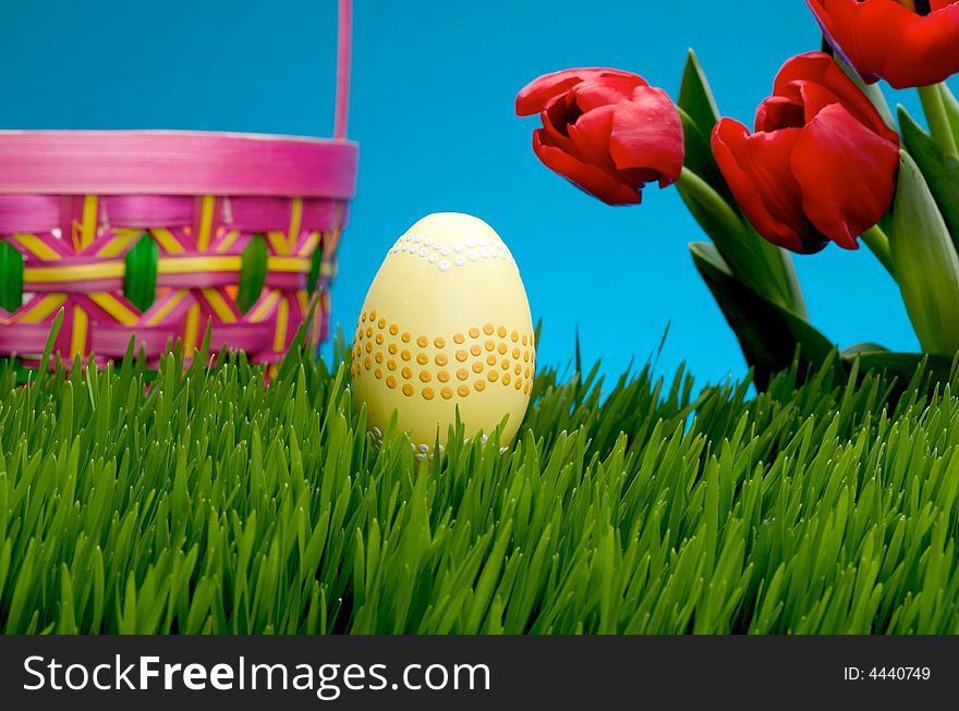 An image of a pastel easter egg in lush grass