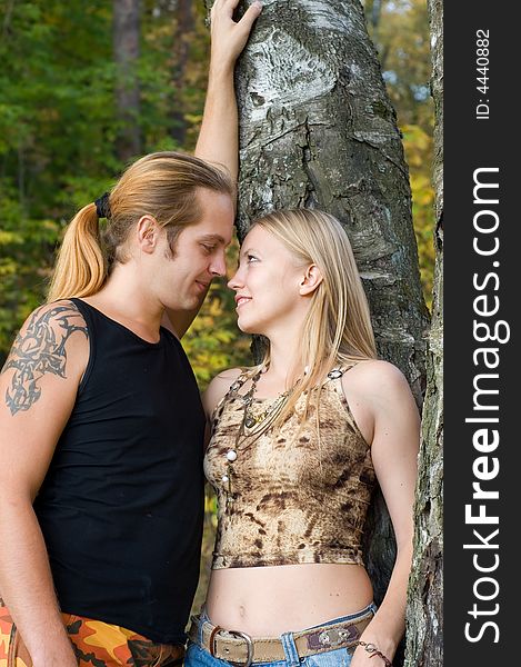 Young couple standing near tree