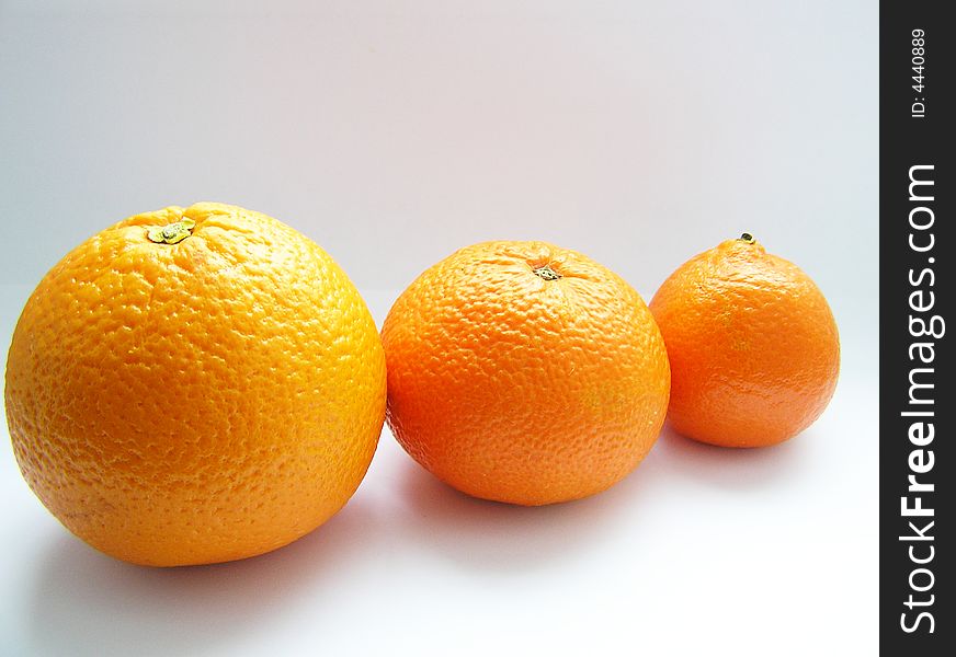 Oranges and tangerine on grey background
