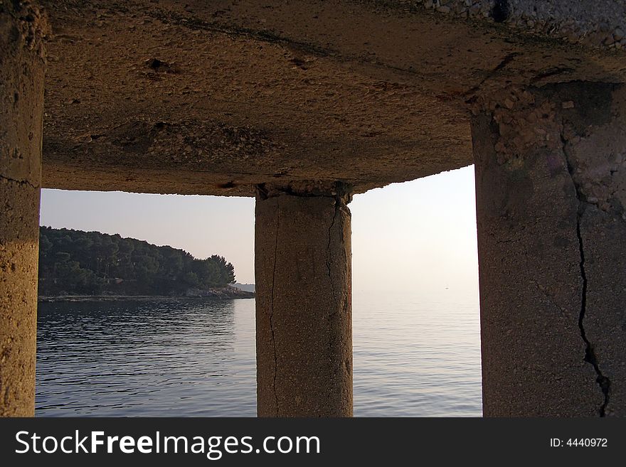 Peninsula view through pillars at sunset