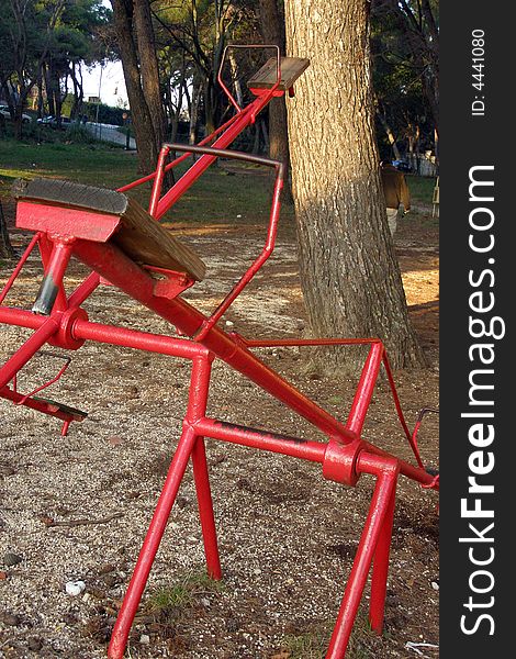 Red vintage seesaw in the playground. Red vintage seesaw in the playground
