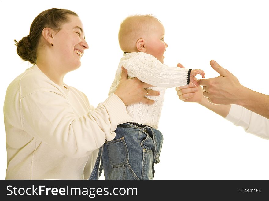 Young boy going from mather's hands to father. Young boy going from mather's hands to father.