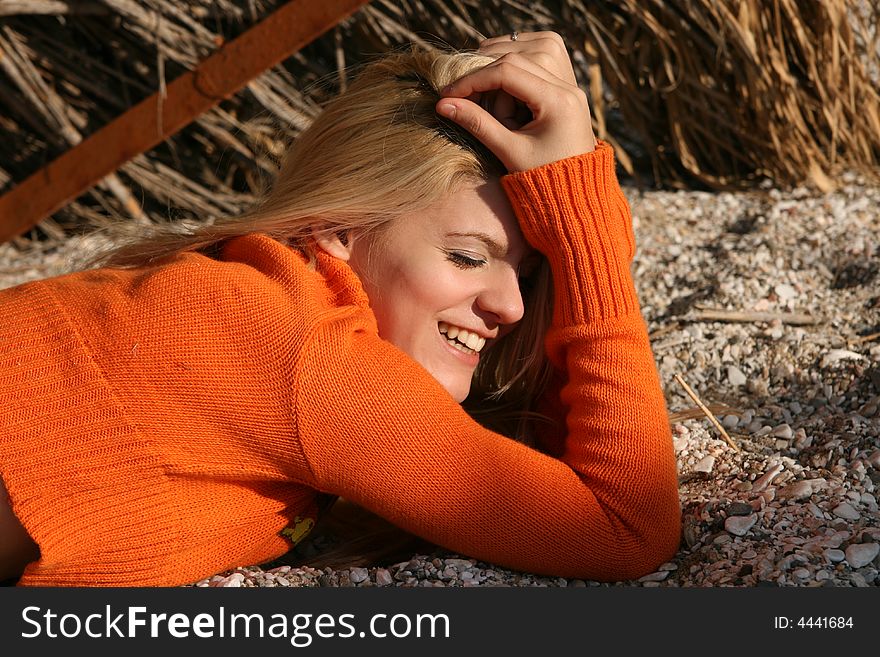 A blonde young woman lying on the ground. A blonde young woman lying on the ground