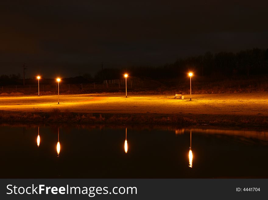 Lamps and reflection light in pond, night scenery. Lamps and reflection light in pond, night scenery