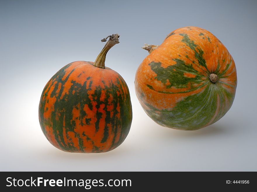 Two pumpkins on  light background,  close up