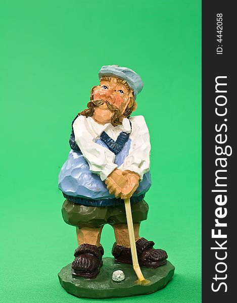 Golf player made of wood on green textured background