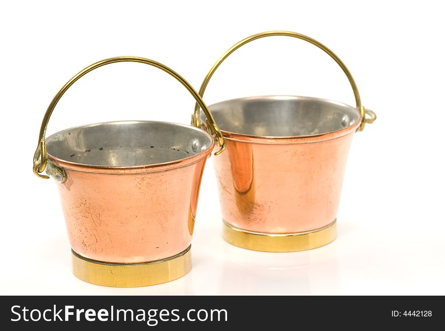 Close up on two old copper buckets