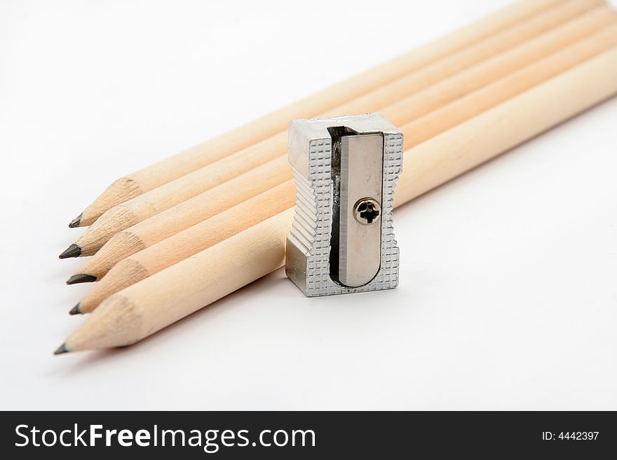 Pencils with pencil sharpener on white