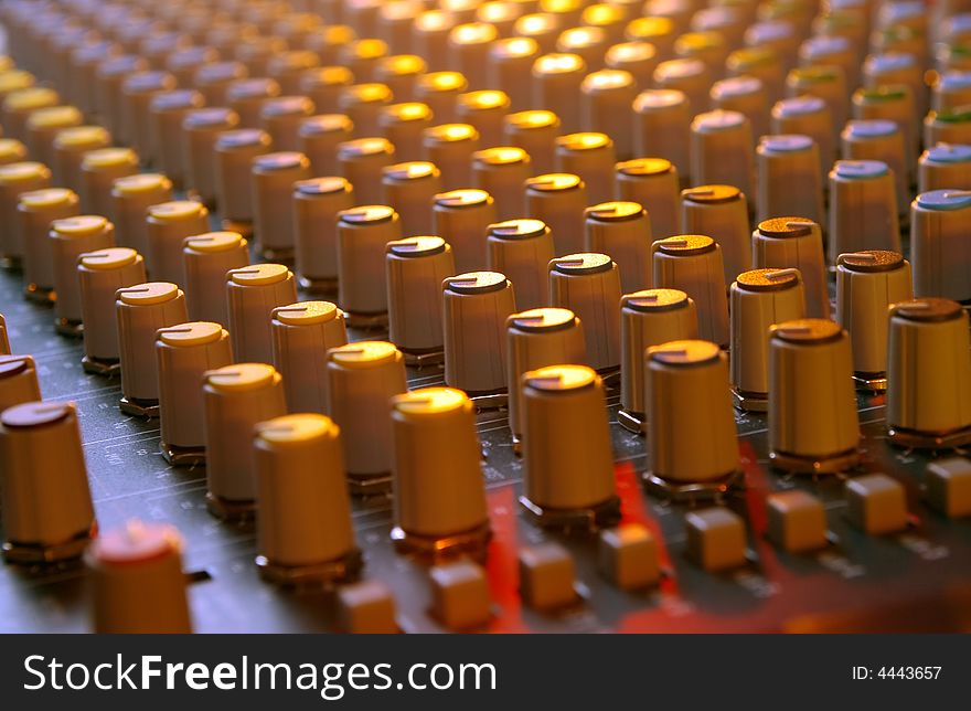 Soundboard mixer under multi-colored lights