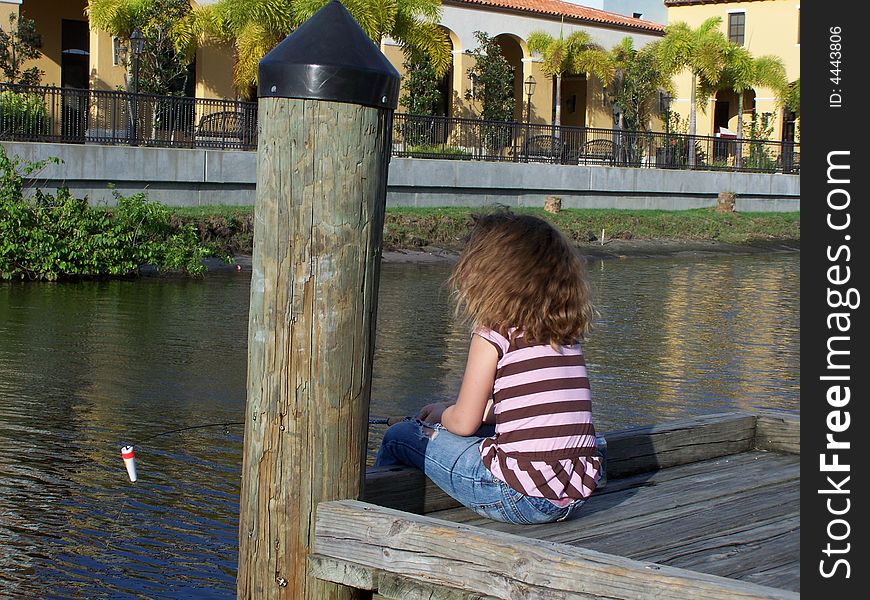 Jazzy sits at end of dock on St. Lucie River waiting paitiently for a bite. Jazzy sits at end of dock on St. Lucie River waiting paitiently for a bite