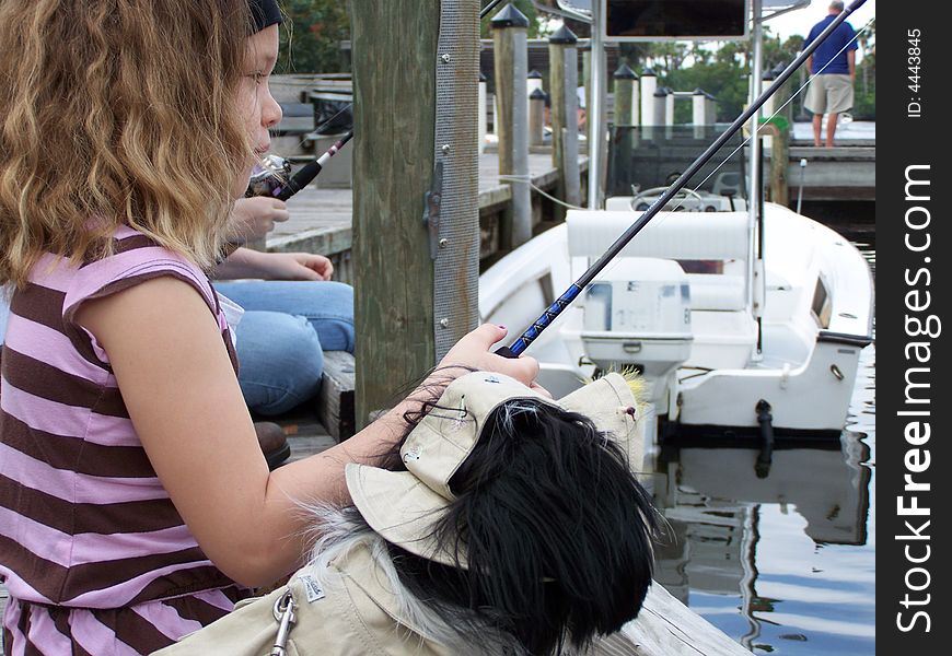 Jazzy fishing with her faithful fishing dog, Lacey,. Jazzy fishing with her faithful fishing dog, Lacey,