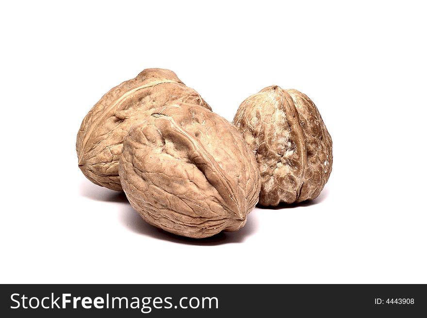 Three walnuts isolated on white.