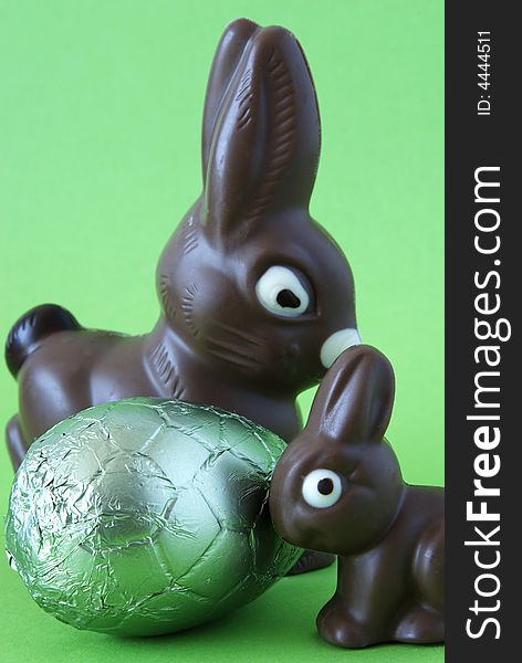 Chocolate easter bunnies with colorful wrapped egg