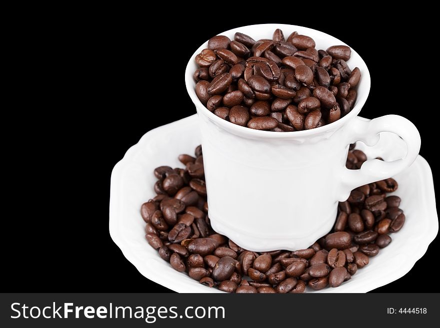 White coffee cup filled with coffee beans