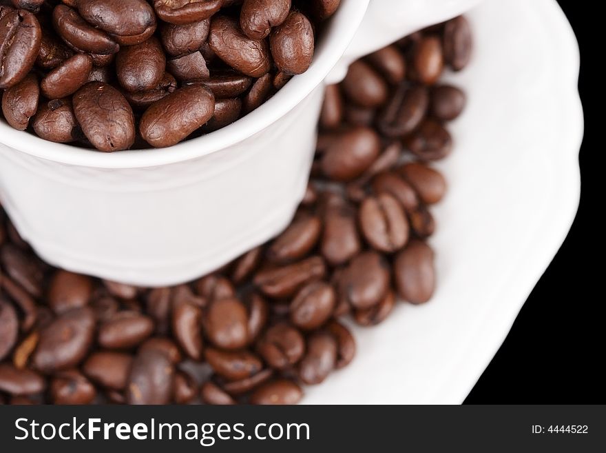 Close-up of a coffee cup filled with coffee beans