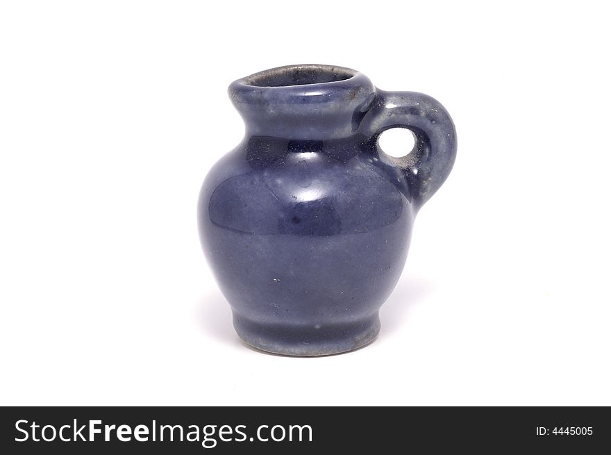 Tiny dark-blue jug isolated on white. Tiny dark-blue jug isolated on white