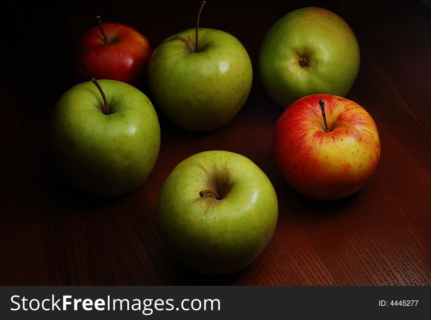 Group of colored apples on the dark background