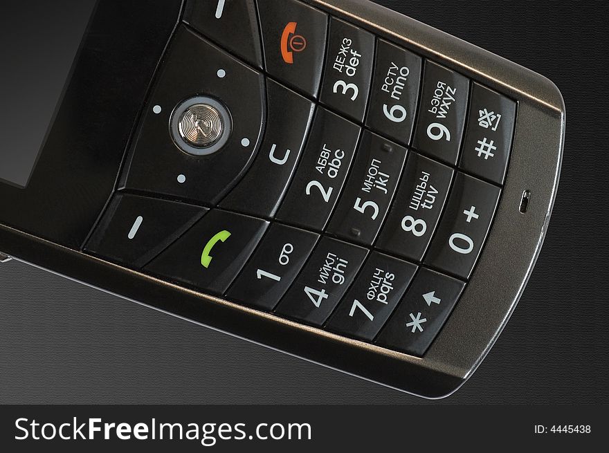 Keypad of mobile phone on the textured black background