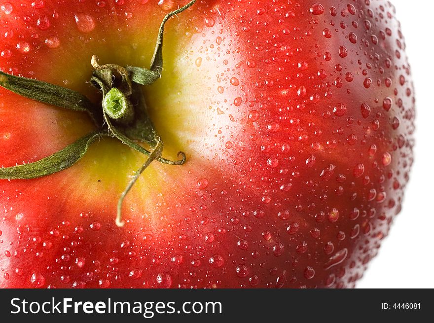 A fresh red apple with tomato twig