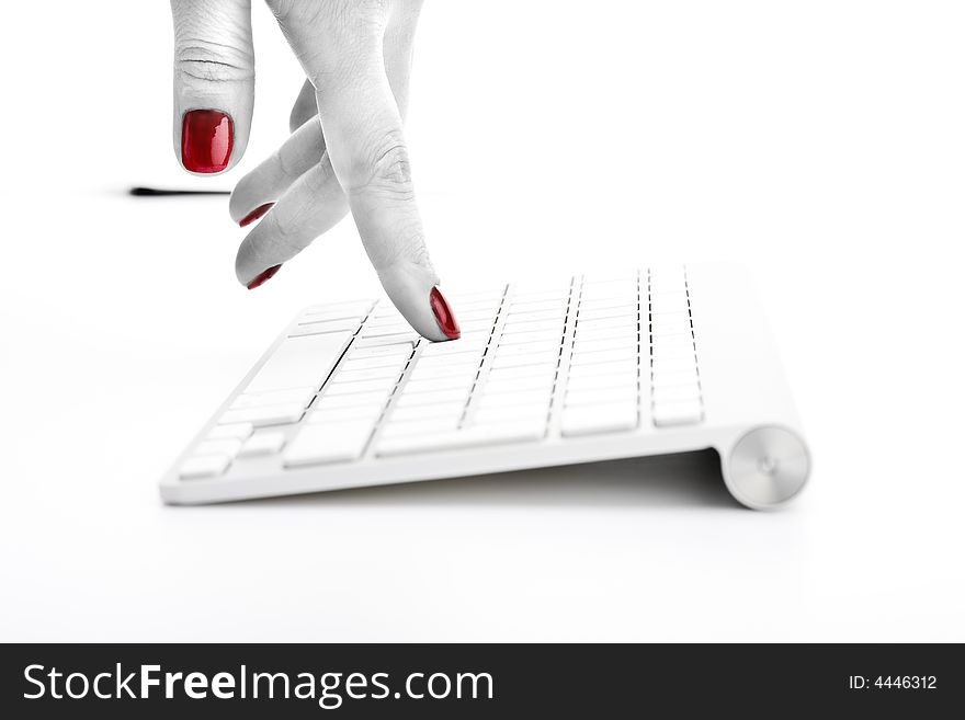 Fingers with red nail touching keyboard